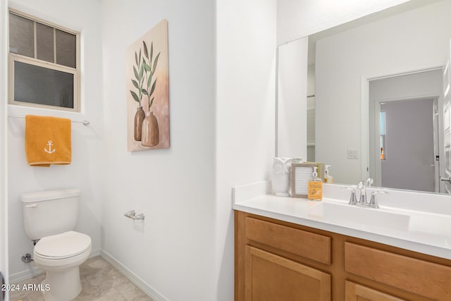 bathroom featuring tile patterned floors, vanity, and toilet