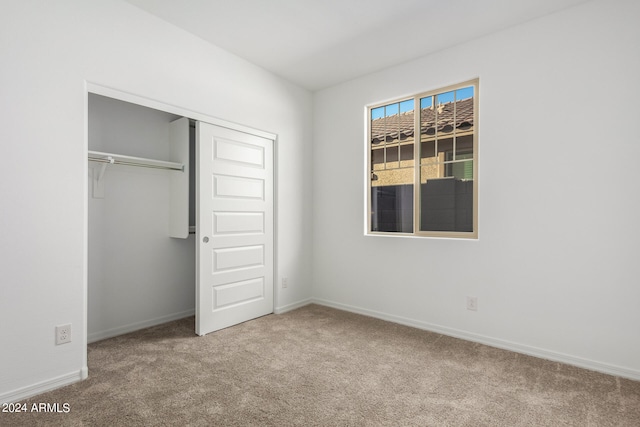 unfurnished bedroom with carpet floors and a closet