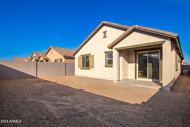 rear view of property featuring a patio area