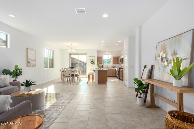 living room featuring a chandelier and light tile patterned floors