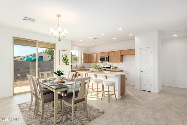 dining space with an inviting chandelier and sink