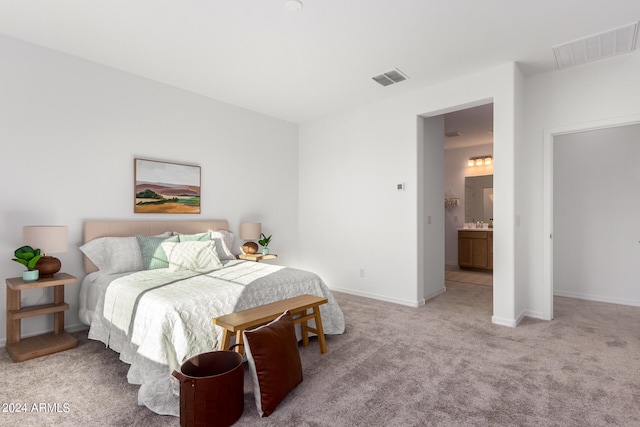 carpeted bedroom with ensuite bathroom