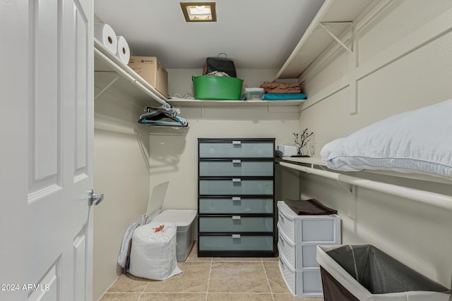 spacious closet with light tile floors