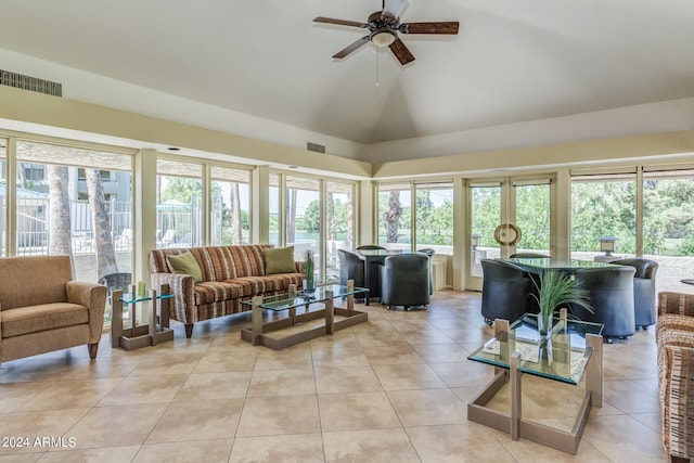 sunroom featuring lofted ceiling and ceiling fan