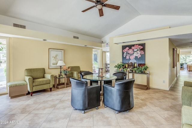 living room with ceiling fan, light tile flooring, and vaulted ceiling