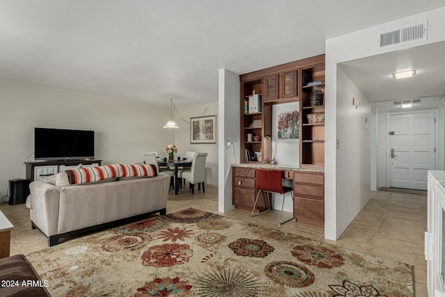 living room featuring built in features and light tile floors