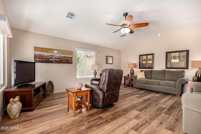 living room with a ceiling fan, light wood finished floors, lofted ceiling, and visible vents