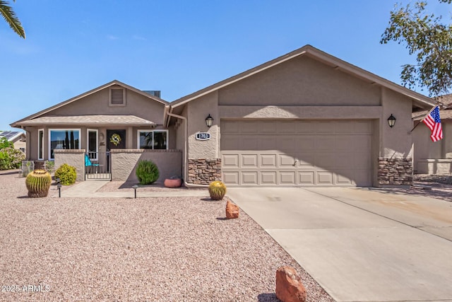 single story home with fence, stone siding, stucco siding, concrete driveway, and an attached garage