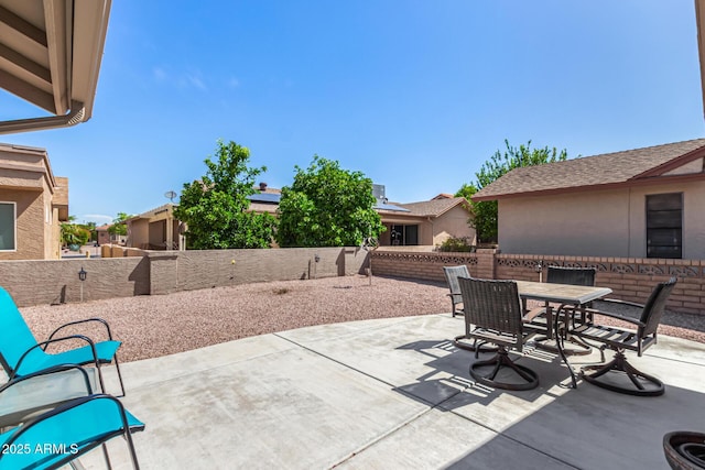 view of patio with outdoor dining space and a fenced backyard