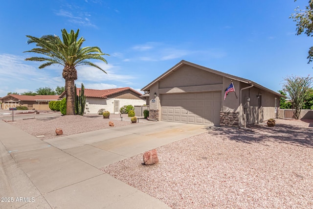 single story home featuring a garage, fence, stucco siding, and driveway