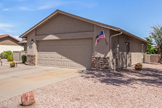 view of front of home featuring a garage, stucco siding, stone siding, and concrete driveway