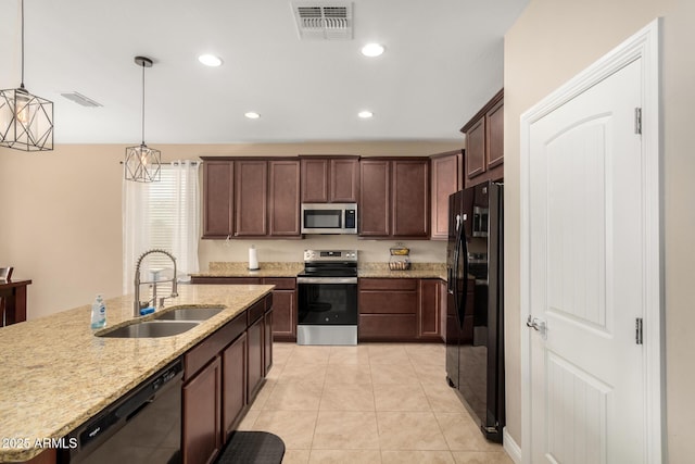 kitchen featuring sink, light tile patterned floors, pendant lighting, light stone countertops, and black appliances