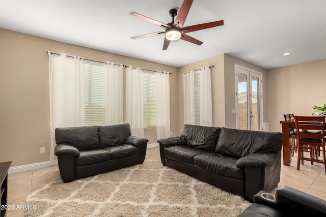 living room featuring ceiling fan and light tile patterned floors