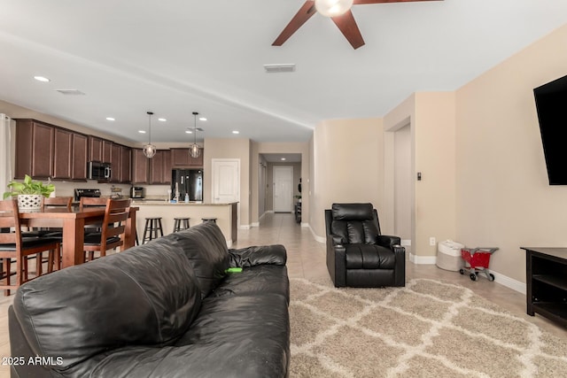 tiled living room with ceiling fan