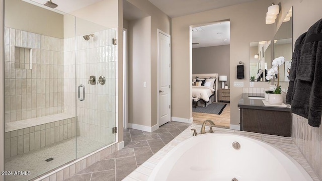 bathroom with vanity and separate shower and tub