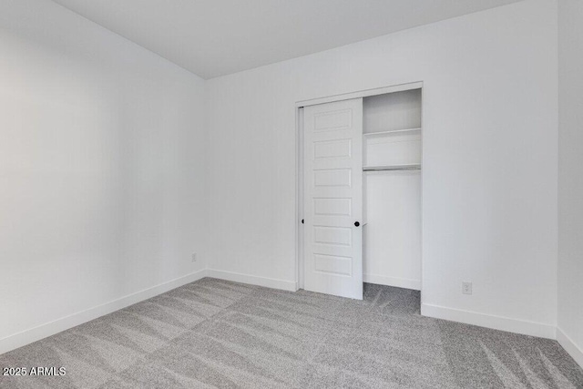 unfurnished bedroom featuring a closet and carpet