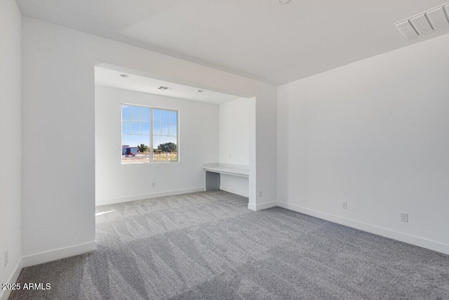 spare room with light colored carpet