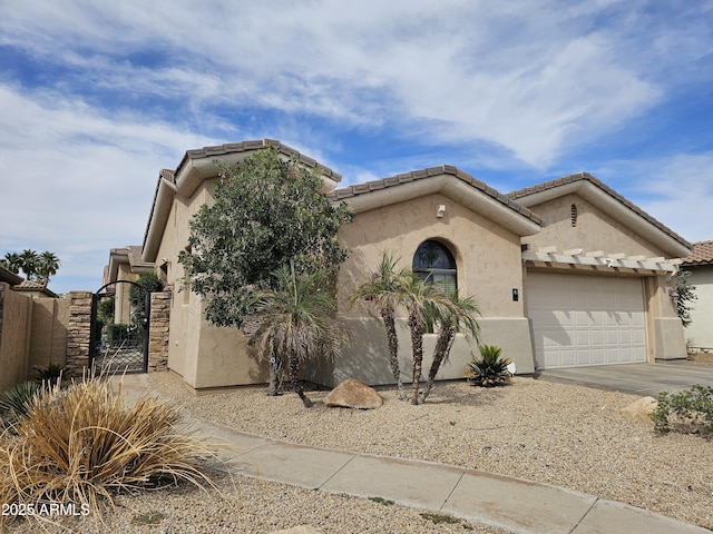 14380 W Monte Vista Rd, Goodyear, AZ 85395 - view of front of property with stucco siding, a gate, concrete driveway, an attached garage, and a tiled roof