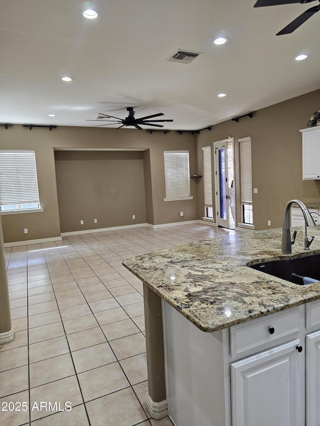14380 W Monte Vista Rd, Goodyear, AZ 85395 - kitchen with a ceiling fan, a sink, open floor plan, white cabinetry, and recessed lighting