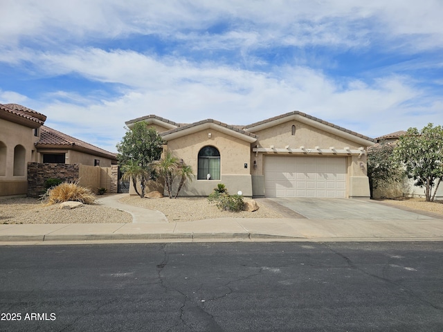14380 W Monte Vista Rd, Goodyear, AZ 85395 - mediterranean / spanish home with driveway, a garage, stucco siding, and a tiled roof