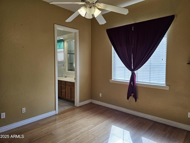 14380 W Monte Vista Rd, Goodyear, AZ 85395 - spare room with light wood-style flooring, ceiling fan, baseboards, and a textured wall