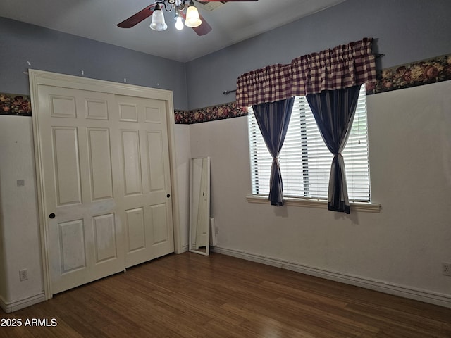 14380 W Monte Vista Rd, Goodyear, AZ 85395 - unfurnished bedroom with wood finished floors, baseboards, ceiling fan, and a closet