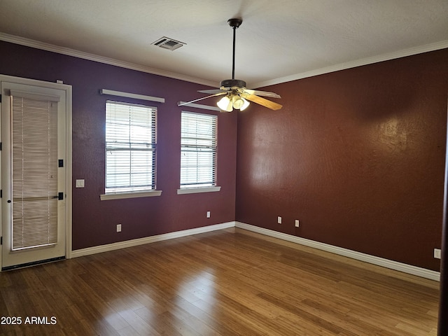 14380 W Monte Vista Rd, Goodyear, AZ 85395 - empty room featuring wood finished floors, baseboards, ceiling fan, and crown molding