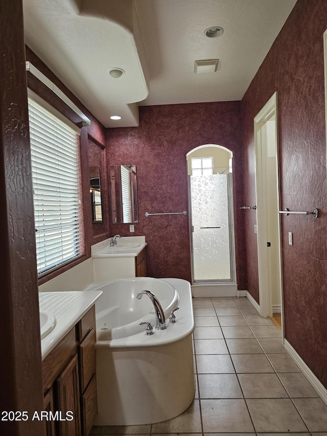 14380 W Monte Vista Rd, Goodyear, AZ 85395 - bathroom with vanity, healthy amount of natural light, a whirlpool tub, and tile patterned flooring