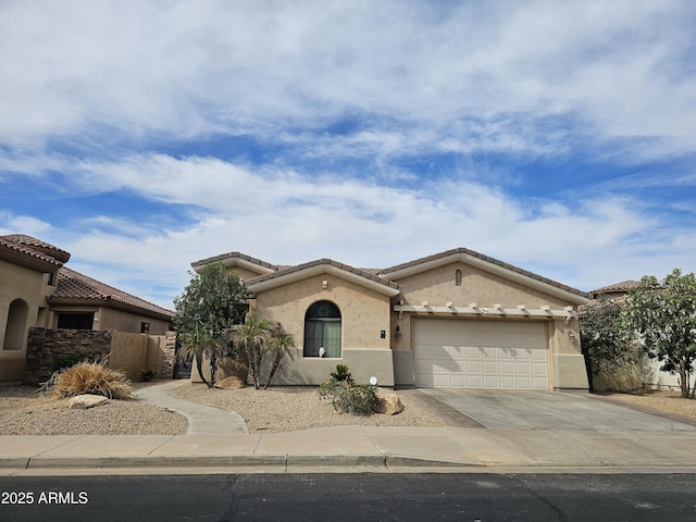 14380 W Monte Vista Rd, Goodyear, AZ 85395 - mediterranean / spanish-style house featuring driveway, an attached garage, stucco siding, and a tiled roof
