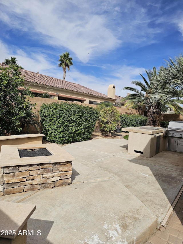 14380 W Monte Vista Rd, Goodyear, AZ 85395 - view of patio featuring exterior kitchen and an outdoor fire pit