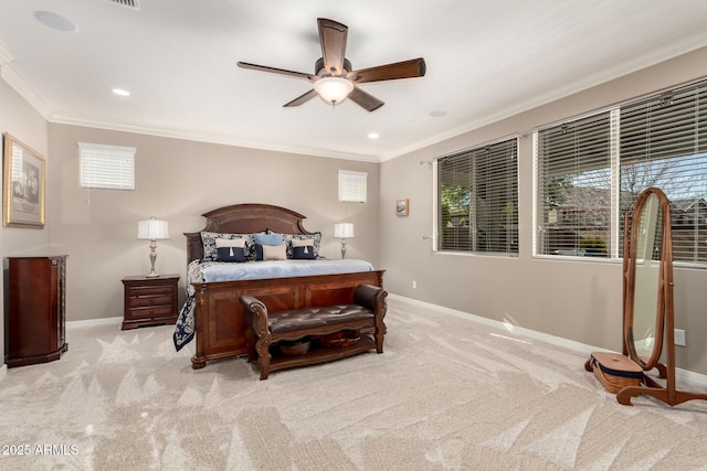 carpeted bedroom with ornamental molding and ceiling fan