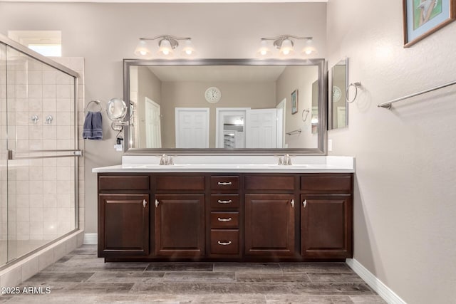 bathroom featuring vanity and a shower with shower door