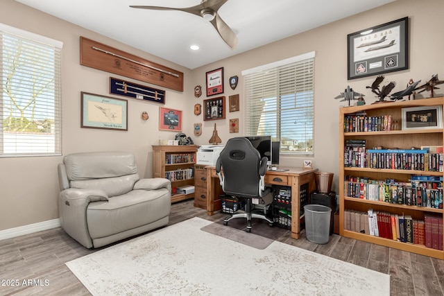 home office featuring hardwood / wood-style flooring and ceiling fan