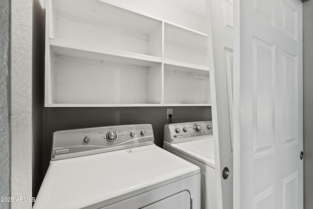 laundry area featuring washer and clothes dryer and laundry area