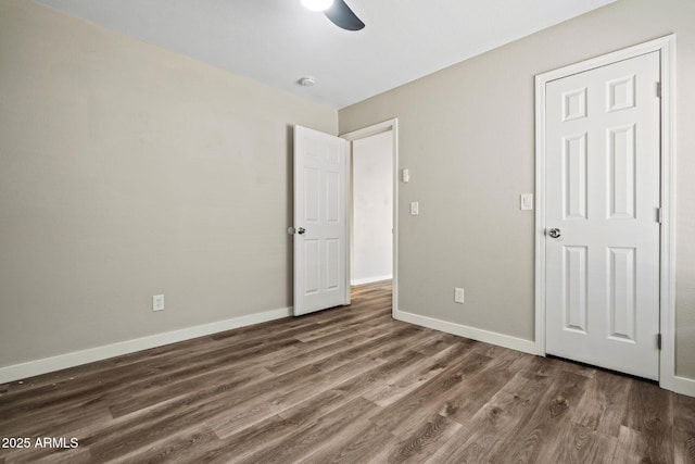 unfurnished bedroom with wood finished floors, ceiling fan, and baseboards