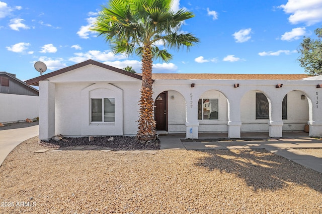 view of front of property featuring a porch and stucco siding