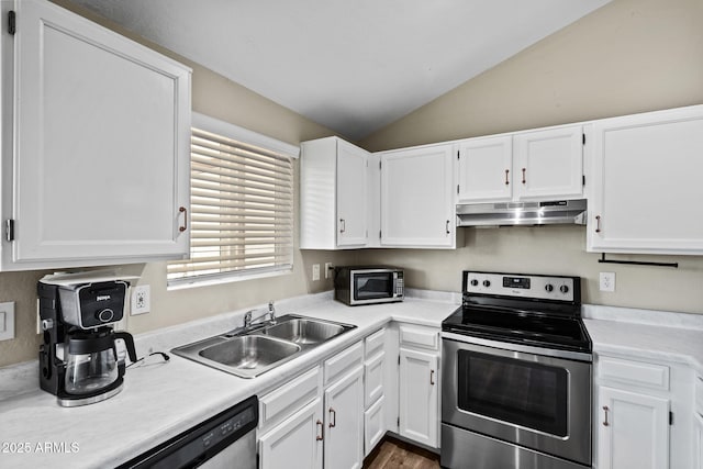 kitchen featuring under cabinet range hood, white cabinetry, a sink, and appliances with stainless steel finishes
