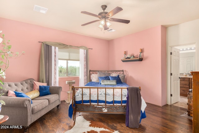 bedroom with dark hardwood / wood-style flooring and ceiling fan