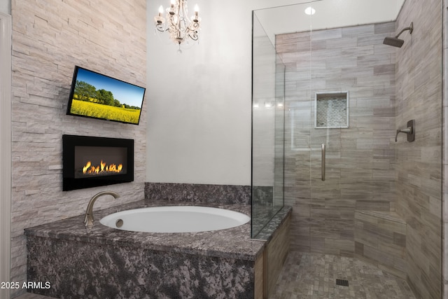 bathroom featuring a warm lit fireplace, a shower stall, and a bath