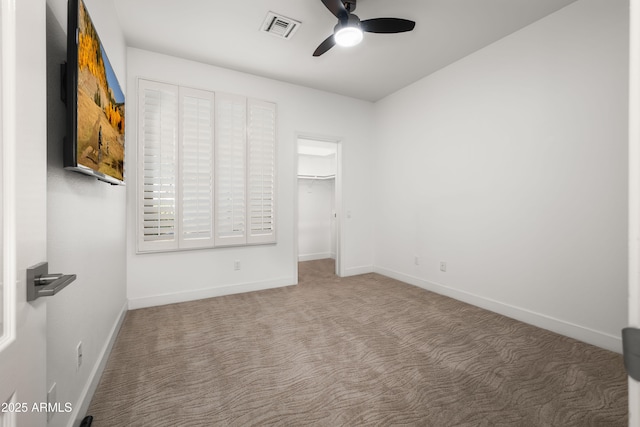 unfurnished bedroom featuring carpet floors, visible vents, ceiling fan, and baseboards