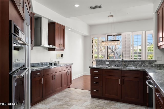 kitchen featuring visible vents, a healthy amount of sunlight, a sink, wall chimney range hood, and black electric cooktop