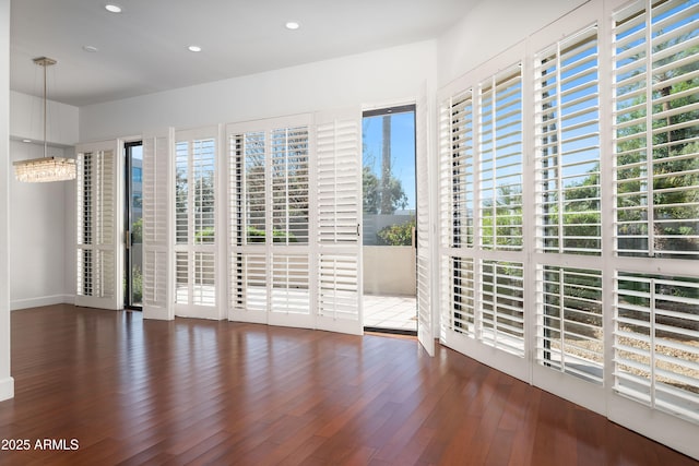 interior space with wood finished floors and recessed lighting