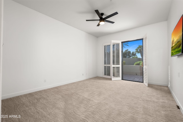 unfurnished room with a ceiling fan, baseboards, and carpet flooring