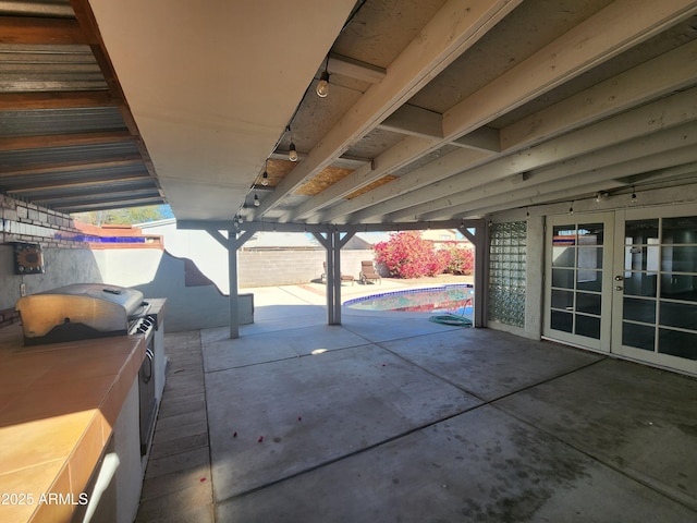 view of patio / terrace featuring a pool, washing machine and dryer, french doors, and fence private yard