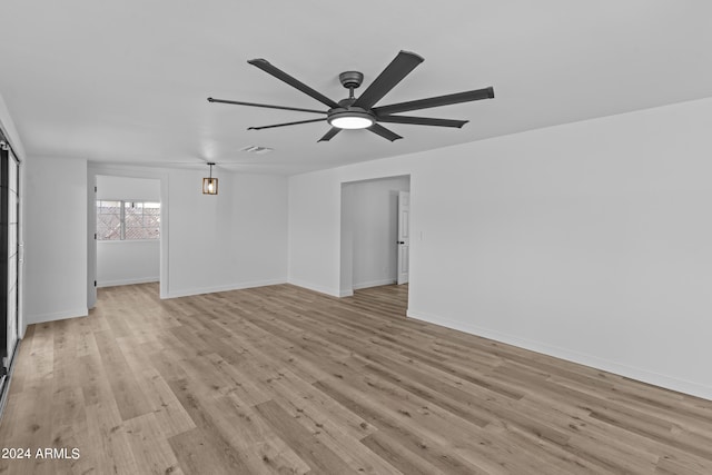 unfurnished living room with visible vents, ceiling fan, baseboards, and light wood-style floors