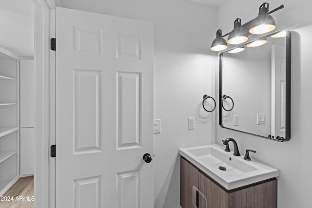 bathroom with wood finished floors and vanity