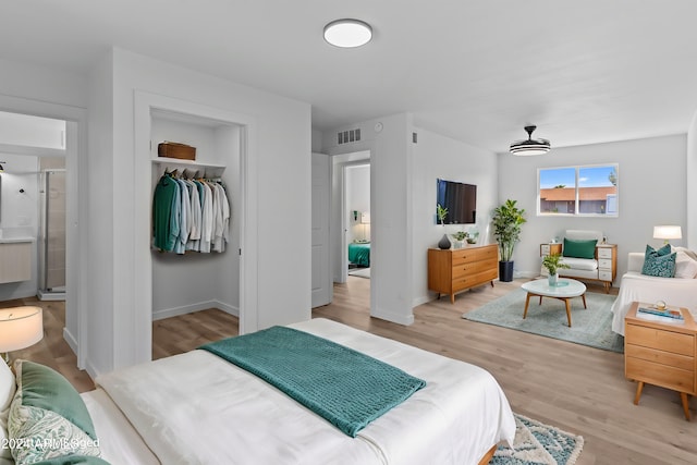 bedroom with visible vents, light wood-type flooring, and baseboards