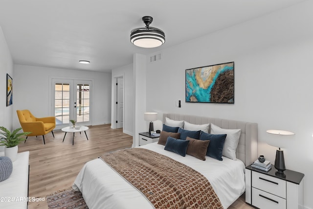 bedroom featuring visible vents, access to outside, and light wood-style flooring