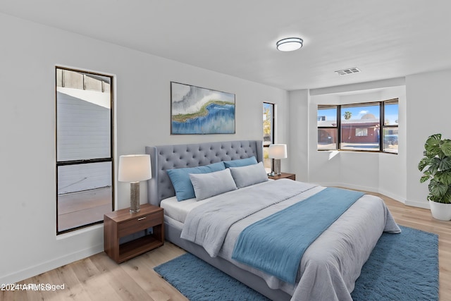 bedroom with visible vents, baseboards, and light wood-style floors