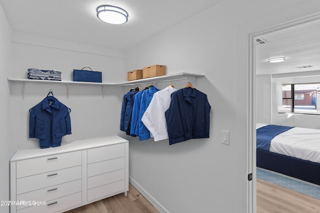 spacious closet featuring visible vents and light wood-style flooring